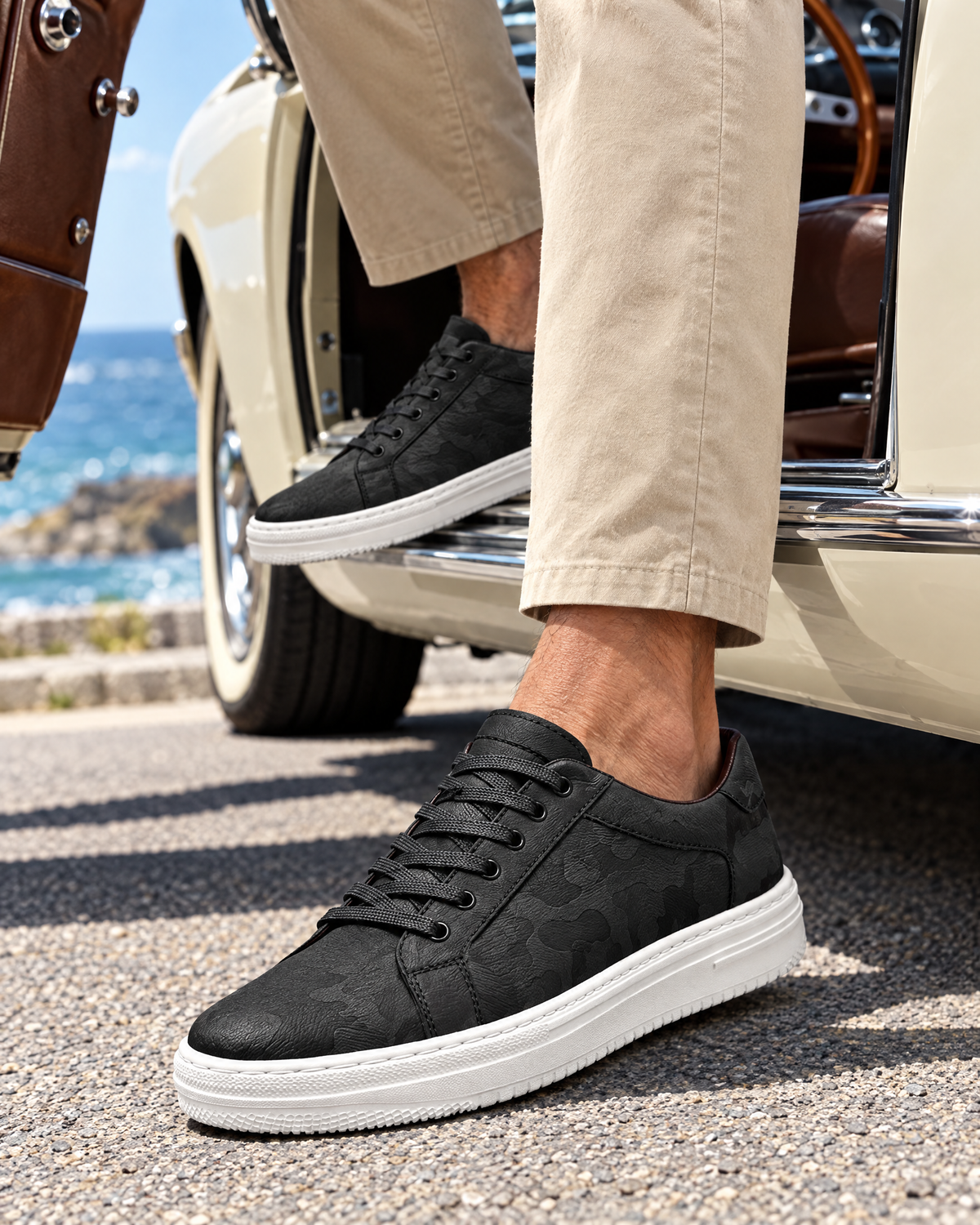 The Savona in Black, stepping out of a car by the sea