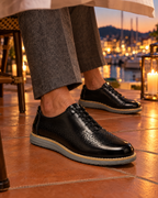 The Padova in Black, worn at a terrace dinner table